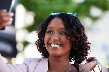 Image showing Phone selfie, black woman and shopping in city for retail discount, fashion influencer or urban market sales. Happy shopper girl taking photograph on smartphone for social media, smile and technology