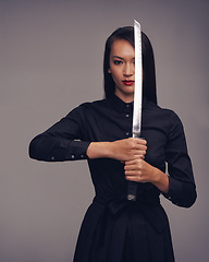 Image showing Portrait, samurai and warrior with an asian woman in studio on a gray background for martial arts or combat. Training, fantasy and weapon with a model ninja ready to defend using self discipline