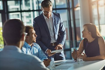 Image showing Man, tablet and business people in meeting for planning, goals and mission at desk with diversity. Teamwork, mobile tech and leadership for vision, collaboration and innovation in financial company