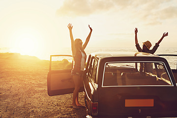 Image showing Road trip, couple of friends and sunset beach for travel, journey and summer holiday celebration. Celebrate, arms in air and vintage, retro car for outdoor vacation, parking and nature drive by ocean