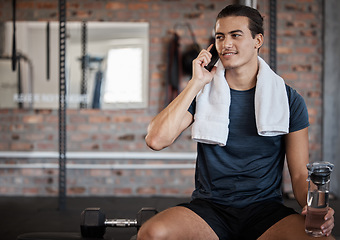 Image showing Fitness, man and phone call with water bottle on bench with smile for conversation after workout at gym. Happy sporty male on smartphone in communication while taking a break from intense training