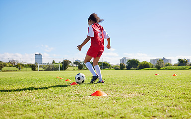 Image showing Football girl child, field and training for fitness, sports and development of balance for control, speed and strong body. Female kid, fast soccer ball dribbling or workout feet on grass for learning