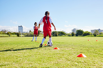 Image showing Soccer, running or sports and a girl team playing with a ball together on a field for practice. Fitness, football and grass with kids training or dribbling on a pitch for competition or exercise