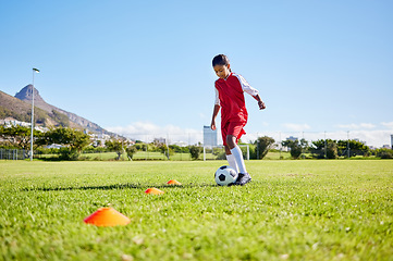 Image showing Football girl kid, training and grass for fitness, speed or balance with sport talent development, control and speed. Female child, fast football dribbling or motivation mindset on field in Cape Town