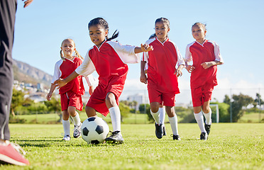 Image showing Soccer, ball or sports and a girl team training or playing together on a field for practice. Fitness, football and grass with kids running or dribbling on a pitch for competition or exercise