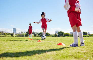 Image showing Soccer, training or running and a girl team playing with a ball together on a field for practice. Fitness, football and grass with sports kids dribbling on a pitch for competition or exercise