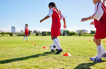 Image showing Football, training or sports and a girl team playing with a ball together on a field for practice. Fitness, soccer and grass with kids running or dribbling on a pitch for competition or exercise