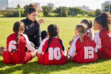 Image showing Coaching, exercise or coach with children for soccer strategy, training and team goals in Canada. Team building, teamwork and woman planning group of girl on football field for game, match or workout