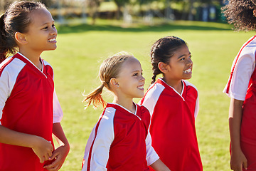 Image showing Girl, soccer group and field with smile, team building or solidarity at sport training, strategy or motivation. Female kids, sports planning and diversity with teamwork, friends and focus in football