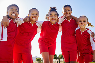 Image showing Football girl, group portrait and field for smile, team building happiness and solidarity at sport training. Female kids, sports diversity and friends with teamwork, learning or soccer with low angle