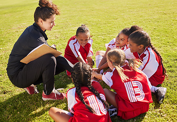 Image showing Huddle, sport or coach with children hands for soccer strategy training or team goals in Canada. Team building, circle or woman and group of girls on football field for game support, match or workout