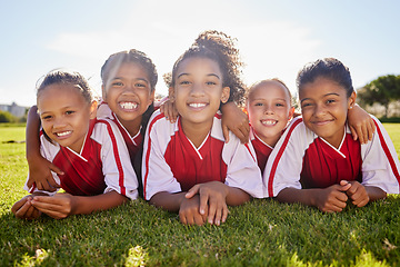 Image showing Girl, soccer group portrait and lying with smile, team building happiness or solidarity to relax at training. Female kids, sports diversity and happy with friends, teamwork or development in football