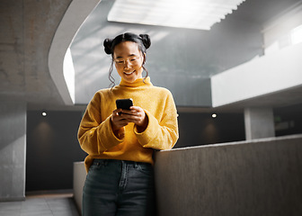 Image showing Happy, woman and texting on phone in office building, relax while on internet, search and reading. Asian, girl and business entrepreneur with smartphone for research, office space or idea in Japan