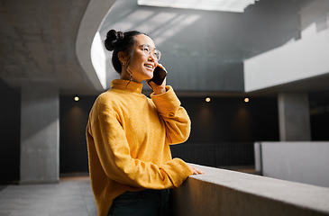 Image showing Phone call, networking and mockup with an asian woman talking while standing in a hallway. Mobile, communication and conversation with an attractive young female speaking on her smartphone indoor