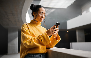 Image showing Woman, phone and texting in office building, thinking and calm while on internet, search and reading. Asian, girl and business entrepreneur with smartphone for research, office space or idea in Japan