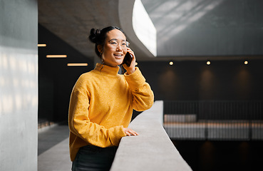 Image showing Phone call, conversation and mockup with an asian woman talking while standing in a hallway. Mobile, networking and communication with an attractive young female speaking on her smartphone indoor