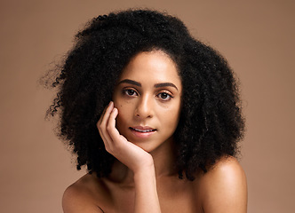 Image showing Black woman, studio portrait and beauty with skincare, cosmetic glow and thinking with afro by backdrop. Model, makeup and natural hair care for aesthetic, wellness and self care by brown backdrop