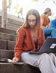 Image showing University, woman on stairs with laptop writing in notebook for school project with focus and motivation for education. College, scholarship and research, student on steps on campus studying for exam