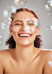 Image showing Bubbles, happy face and beauty woman in studio for skincare cosmetics, natural skin and dermatology. Facial makeup, health and wellness of comic model person with luxury body product glow and peace