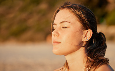 Image showing Face, relax and meditation with a woman outdoor in nature, standing alone for zen, calm or serenity. Mindset, peace and mental health with an attractive young female breathing outside for mindfulness