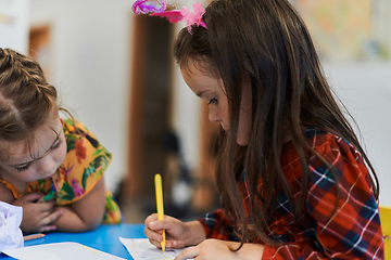 Image showing Creative kids sitting in a preschool institution, draw and have fun while they get an education