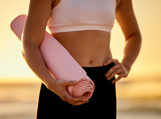 Image showing Yoga mat, closeup and woman at a beach for meditation, zen and relax for wellness, exercise and health. Fitness, zoom and girl at the sea for yoga or pilates, breathing and calm before ocean workout