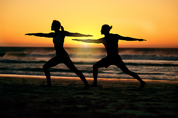 Image showing Couple, silhouette and beach yoga at sunset for health, fitness and wellness. Warrior pose, zen chakra and man and woman stretching, training and practicing pilates for balance outdoors at seashore.