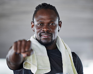 Image showing Black man, boxing and fist with fitness portrait, sports and martial arts with exercise and earphones for music. Athlete, boxer and MMA fighter with towel, workout and training with audio streaming