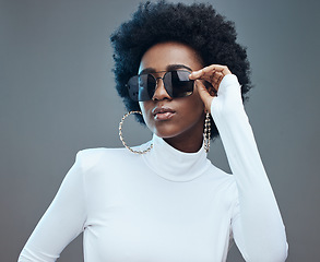 Image showing Sunglasses, fashion and young black woman with gen z style and designer with trendy brand against studio background. Afro hair, edgy and girl, marketing with fashion model and stylish beauty