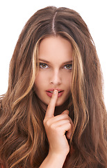 Image showing Secret, beauty and young woman portrait with natural beauty and whisper hand sign. Model, mouth and isolated person with white studio background looking sexy and beautiful with silence gesture