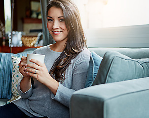 Image showing Coffee, woman and portrait of a person at home on a living room sofa with a smile in the morning. Drink, happy person and lens flare on a lounge house couch with tea feeling happiness in a room