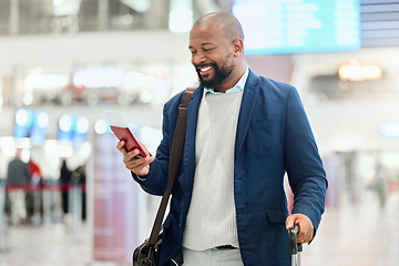 Image showing Businessman, phone and smile with luggage for travel, journey or texting in communication at the airport. Happy black man, person or employee holding smartphone for chatting, traveling or work trip