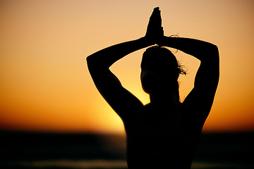 Image showing Prayer hands, meditation and silhouette of woman at sunset outdoors for health and wellness. Pilates fitness, zen shadow and female yogi with namaste hand pose for chakra, training and yoga exercise.