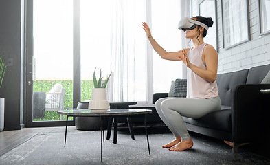 Image showing VR, metaverse and futuristic with a woman in the living room of her home using a headset to access a 3d game. Technology, virtual reality and gaming with a female gamer using ai to play games