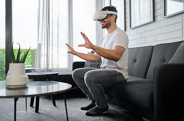 Image showing Virtual reality, futuristic technology and man on sofa with headset for interactive, online and 3d games ux. User interface, digital tech and male relax with vr for metaverse, cyberspace and gaming