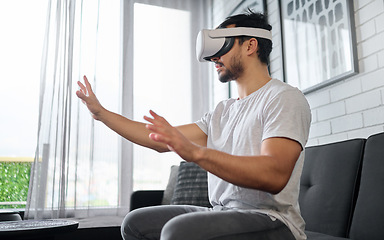 Image showing Virtual reality, hands and man on sofa with futuristic headset for interactive, online and 3d games ux. Technology, digital tech and male relax with vr glasses for metaverse, cyberspace and gaming