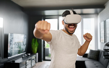 Image showing VR, angry and man boxing with glasses, training for a fight and match. Futuristic, digital sports and gamer punching while playing in an augmented reality game online with technology in a house