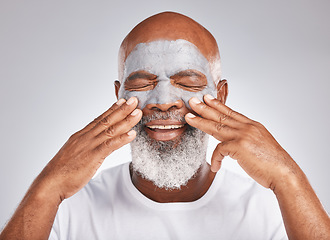 Image showing Skincare, hands or old man with facial cream marketing or advertising luxury beauty product for self care. Studio background, cosmetics or elderly black man with a happy smile applying face mask