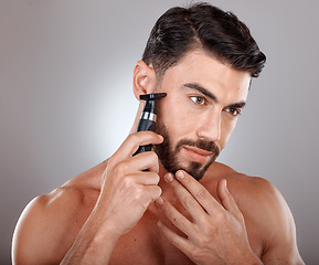 Image showing Man, shaving facial beard and razor hair removal, grooming hygiene cleaning or skincare dermatology wellness in grey studio background. Model, face beauty and shave for cosmetics self care cleaning