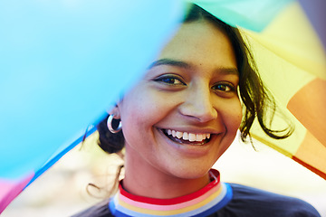 Image showing Rainbow, flag and portrait with an indian woman in celebration of lgbt equality, freedom or gay pride. Community, support or human rights with a gender neutral or non binary female celebrating lgbtq