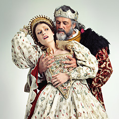 Image showing Theater, king and queen in costume with violence in in crown and renaissance clothes in studio. Art, cosplay and larp, couple in medieval play, royal history character and woman in distress with man.