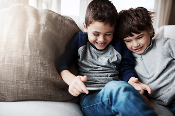 Image showing Boy siblings, tablet and sofa with laugh, funny meme and digital app for gaming, streaming or comedy. Kids, couch and mobile tech on social media, video or comic movie in family home for love bonding