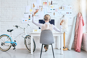 Image showing Designer woman, music and desk in workshop by moodboard, relax and dance on break for inspiration. Startup fashion expert, studio and sitting at table for motivation, vision or goal with headphones