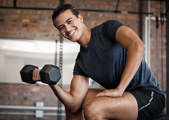 Image showing Portrait, fitness and dumbbell with a sports man training in a gym for strong or healthy muscles. Happy. exercise and weightlifting with a male athlete or bodybuilder in a health club for a workout