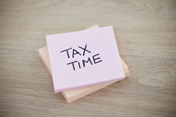 Image showing Tax, planning and sticky note with reminder for finance, audit and wealth on a desk. Accounting, payment and paper with a message for taxation deadline, returns and strategy with money on a table