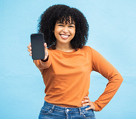 Image showing Happy black woman, portrait or phone screen mockup on isolated blue background in social media app or web design. Smile, student or model on technology mock up, city contact communication or branding