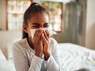 Image showing Health, covid and sick black girl blowing nose in home bedroom. Wellness, healthcare and kid with tissue to wipe for virus, infection or cold, flu or fever, allergy or corona illness in house alone.