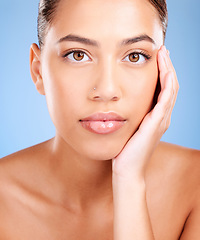 Image showing Portrait, skincare and woman with natural beauty, cosmetics and on blue studio background. Face, female and girl with makeup, treatment for glow and luxury routine for smooth, clear and soft skin.