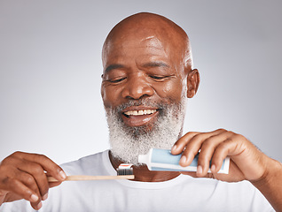 Image showing Dental, toothbrush and product with face of black man for oral hygiene, teeth cleaning and self care. Beauty, cosmetics and grooming with senior model and toothpaste for brushing teeth and health