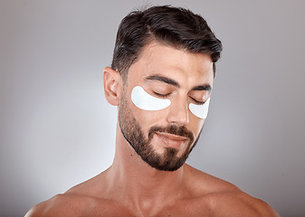 Image showing Skincare, beauty and man with mask for eyes on gray background for wellness, facial treatment and dermatology. Grooming, luxury spa and male with face patch, eye pads and cosmetics products in studio